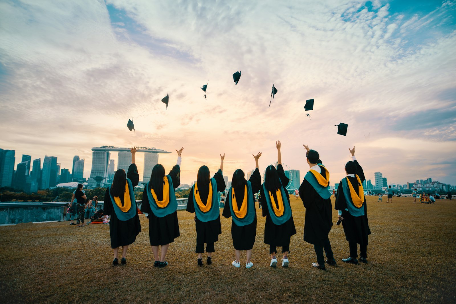 Graduating students throwing their caps in the air